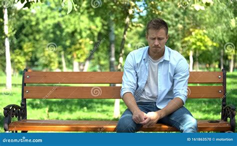 man sitting on the bench|sad man sitting on bench.